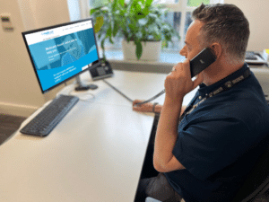 medicash staff member sat at desk helping customers on the phone